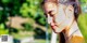 A woman with her eyes closed in a park.