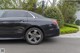 A black car parked in front of a building.